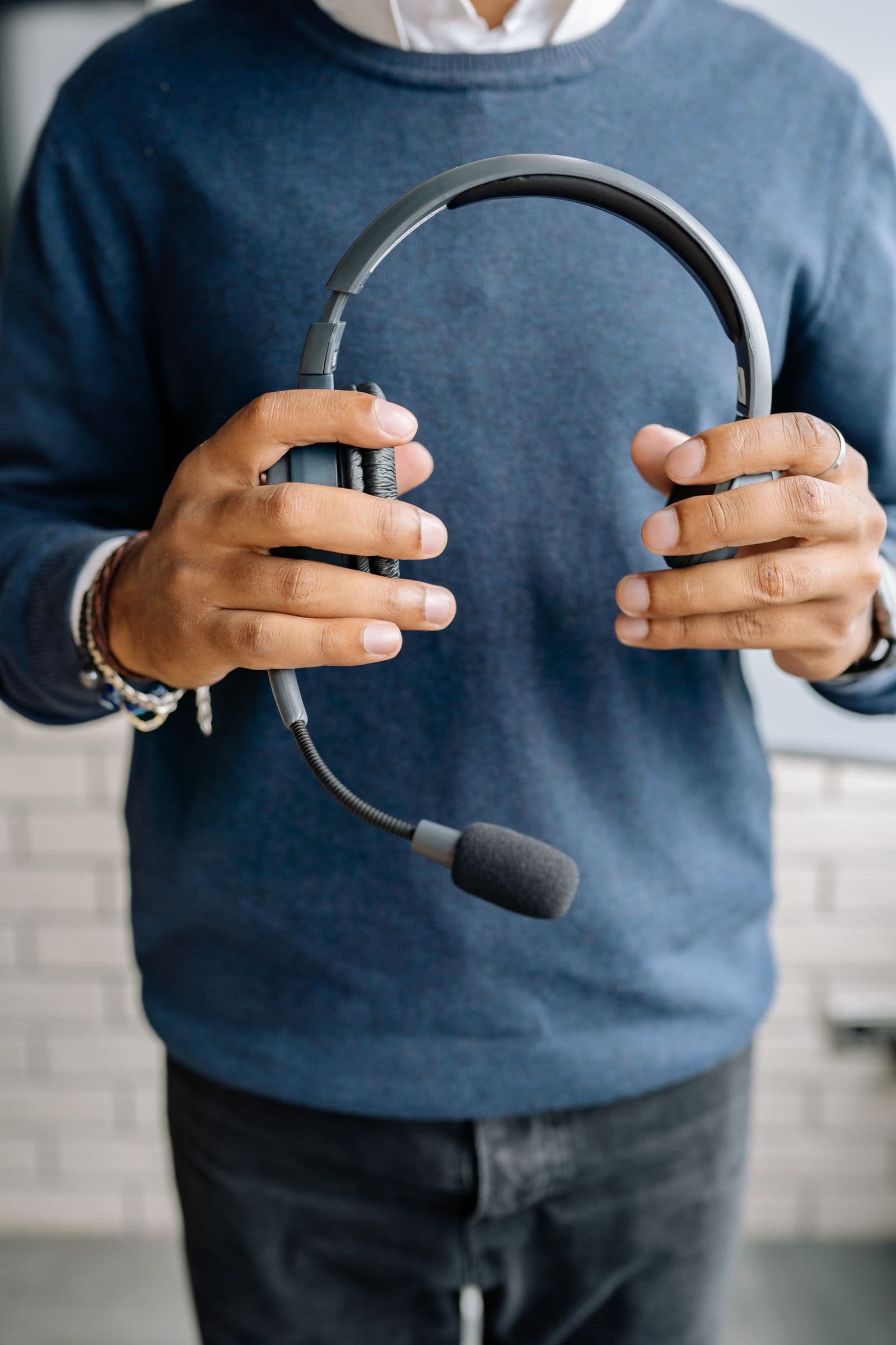 Support specialist holding a headset, ready to assist clients